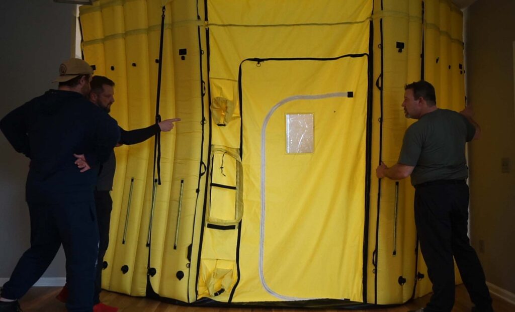 Contractors building inflatable panels into wall